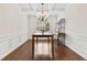 Formal dining room with wainscoting, a coffered ceiling, and hardwood floors at 5310 Corinth Ct, Cumming, GA 30040