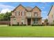 Charming two-story brick home with a well-manicured lawn and inviting curb appeal at 5310 Corinth Ct, Cumming, GA 30040