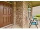 Close-up of the front porch with brick columns and blue seating at 5310 Corinth Ct, Cumming, GA 30040