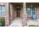Inviting front porch with brick columns and a cozy seating area at 5310 Corinth Ct, Cumming, GA 30040