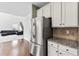 This kitchen features stainless steel appliances, granite countertops, and white cabinets at 5310 Corinth Ct, Cumming, GA 30040