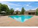 Outdoor pool area with lounge furniture and a nearby building with covered seating at 5310 Corinth Ct, Cumming, GA 30040