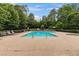 Outdoor community pool area surrounded by lounge chairs and mature trees at 5310 Corinth Ct, Cumming, GA 30040