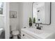 Updated bathroom featuring modern fixtures, sink, toilet, and stylish mirror at 1712 Evans Sw Dr, Atlanta, GA 30310