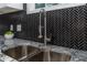 Kitchen sink featuring a stainless steel faucet and trendy black tile backsplash at 1712 Evans Sw Dr, Atlanta, GA 30310