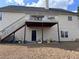 Backyard view of home featuring a raised deck with stairs and lower level entrance at 3345 Stoneleigh Run Dr, Buford, GA 30519