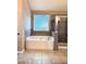 Bright bathroom featuring a soaking tub, separate shower, and tile accents at 3345 Stoneleigh Run Dr, Buford, GA 30519