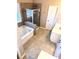 Bathroom showcasing a soaking tub, glass shower enclosure, and tiled flooring at 3345 Stoneleigh Run Dr, Buford, GA 30519