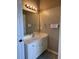 This bathroom features a single sink vanity, a well-lit mirror, and tan walls at 3345 Stoneleigh Run Dr, Buford, GA 30519