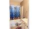 This bathroom offers a single sink vanity and a shower-tub combo with dolphin-themed shower curtain at 3345 Stoneleigh Run Dr, Buford, GA 30519