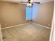 A clean bedroom is carpeted and has a lighted ceiling fan and a bright window at 3345 Stoneleigh Run Dr, Buford, GA 30519