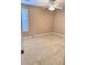 The carpeted bedroom includes a lighted ceiling fan and a large window for natural light at 3345 Stoneleigh Run Dr, Buford, GA 30519