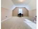 Finished attic room with bright light from large window; potential home office or playroom at 3345 Stoneleigh Run Dr, Buford, GA 30519