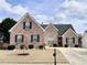 Charming brick home featuring a well-manicured lawn and traditional architectural details at 3345 Stoneleigh Run Dr, Buford, GA 30519