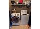 A laundry area is shown with a Samsung washing machine, a dryer, and wire racks for storage at 3345 Stoneleigh Run Dr, Buford, GA 30519