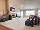 Spacious living room featuring a fireplace, a ceiling fan, and plush carpet flooring at 3345 Stoneleigh Run Dr, Buford, GA 30519