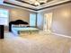 Relaxing main bedroom boasting a tray ceiling, neutral tones, and a comfortable king-sized bed at 3345 Stoneleigh Run Dr, Buford, GA 30519