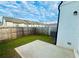 A fenced backyard offers outdoor living space with grass and a small patio pad at 124 Auburn Run Ln, Auburn, GA 30011