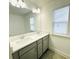 Double vanity bathroom, with tile floors and a large mirror at 124 Auburn Run Ln, Auburn, GA 30011