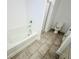 Full bathroom featuring a tub, separate stand-up shower, and tiled flooring at 124 Auburn Run Ln, Auburn, GA 30011