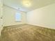 Neutral bedroom featuring carpet, window, and fresh paint at 124 Auburn Run Ln, Auburn, GA 30011