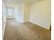 Spacious bedroom with neutral carpet, a window, and a closet at 124 Auburn Run Ln, Auburn, GA 30011