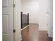 Hallway features hardwood floors, white walls, and a dark wood banister at 124 Auburn Run Ln, Auburn, GA 30011