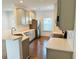 Bright, updated kitchen with stainless steel appliances, gray cabinets and hardwood floors at 124 Auburn Run Ln, Auburn, GA 30011