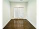 Bright room featuring hardwood flooring and double doors with a view to the outside at 124 Auburn Run Ln, Auburn, GA 30011