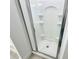 Modern walk-in shower featuring glass door and built-in shelving at 124 Auburn Run Ln, Auburn, GA 30011