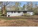 Exterior view of home showing a small, newly constructed deck with a door and black framed windows at 1383 Palmer Sw Pl, Mableton, GA 30126