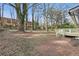A spacious backyard featuring bare trees and a wooden deck attached to the house at 1383 Palmer Sw Pl, Mableton, GA 30126