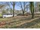 Large backyard featuring scattered trees and a partially fenced perimeter around the property at 1383 Palmer Sw Pl, Mableton, GA 30126