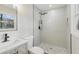 Updated bathroom featuring a walk-in shower with rain shower head and decorative pebble-style flooring at 1383 Palmer Sw Pl, Mableton, GA 30126