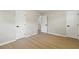 The bedroom has neutral walls, wood floors, white trim and three doors for easy access to other parts of the home at 1383 Palmer Sw Pl, Mableton, GA 30126