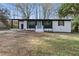 Charming renovated home featuring a blue front door and modern black and white accents at 1383 Palmer Sw Pl, Mableton, GA 30126
