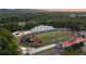 Aerial showcasing the local school's outdoor athletic complex which includes a football field and track at 537 Pearl St, Cumming, GA 30040