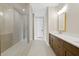 Bathroom featuring long vanity and walk-in glass shower; bright neutral color palette at 537 Pearl St, Cumming, GA 30040