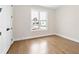 Light-filled bedroom features hardwood floors and a large window overlooking the outdoors at 537 Pearl St, Cumming, GA 30040