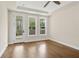 Bright bedroom with wood floors and a ceiling fan; natural light streams through multiple windows at 537 Pearl St, Cumming, GA 30040