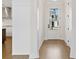 Bright entryway with hardwood floors, a glass panel front door and white trim at 537 Pearl St, Cumming, GA 30040