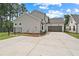 Two-story home with two-car garage, spacious driveway, and manicured lawn and back yard at 537 Pearl St, Cumming, GA 30040