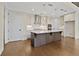Spacious kitchen with stainless steel appliances, hardwood floors, and center island at 537 Pearl St, Cumming, GA 30040