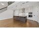 Modern kitchen featuring hardwood floors, stainless steel appliances, and a center island at 537 Pearl St, Cumming, GA 30040