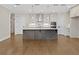 Modern kitchen featuring hardwood floors, stainless steel appliances, and a center island at 537 Pearl St, Cumming, GA 30040
