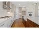 Well-lit kitchen with stainless steel appliances, hardwood floors, and center island at 537 Pearl St, Cumming, GA 30040