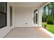 This open-air patio features light gray siding, white trim, and a door with glass panel at 537 Pearl St, Cumming, GA 30040