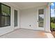This is an open-air patio, with light gray siding, white trim, and two doors with glass panels at 537 Pearl St, Cumming, GA 30040