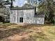 Backyard featuring a patio area and sliding glass doors, providing easy access to the outdoor space at 5463 Forest East Ln, Stone Mountain, GA 30088