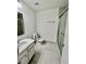Bathroom with a white single sink vanity, toilet and shower/tub combination with gray tiling at 5463 Forest East Ln, Stone Mountain, GA 30088